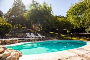 Piscina de relax en Nono rodeada de naturaleza y cabañas.